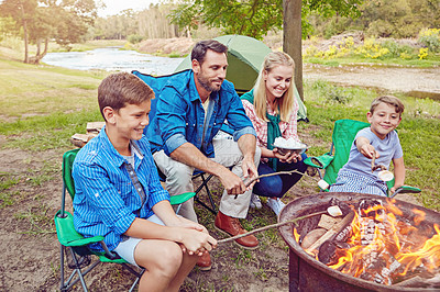 Buy stock photo Cropped shot of a family of four camping in the woods