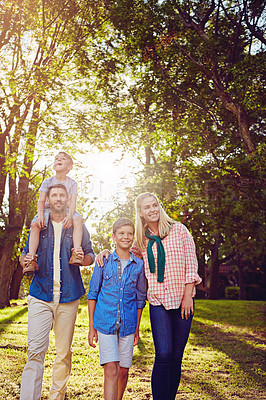 Buy stock photo Cropped shot of a family of four walking in the woods