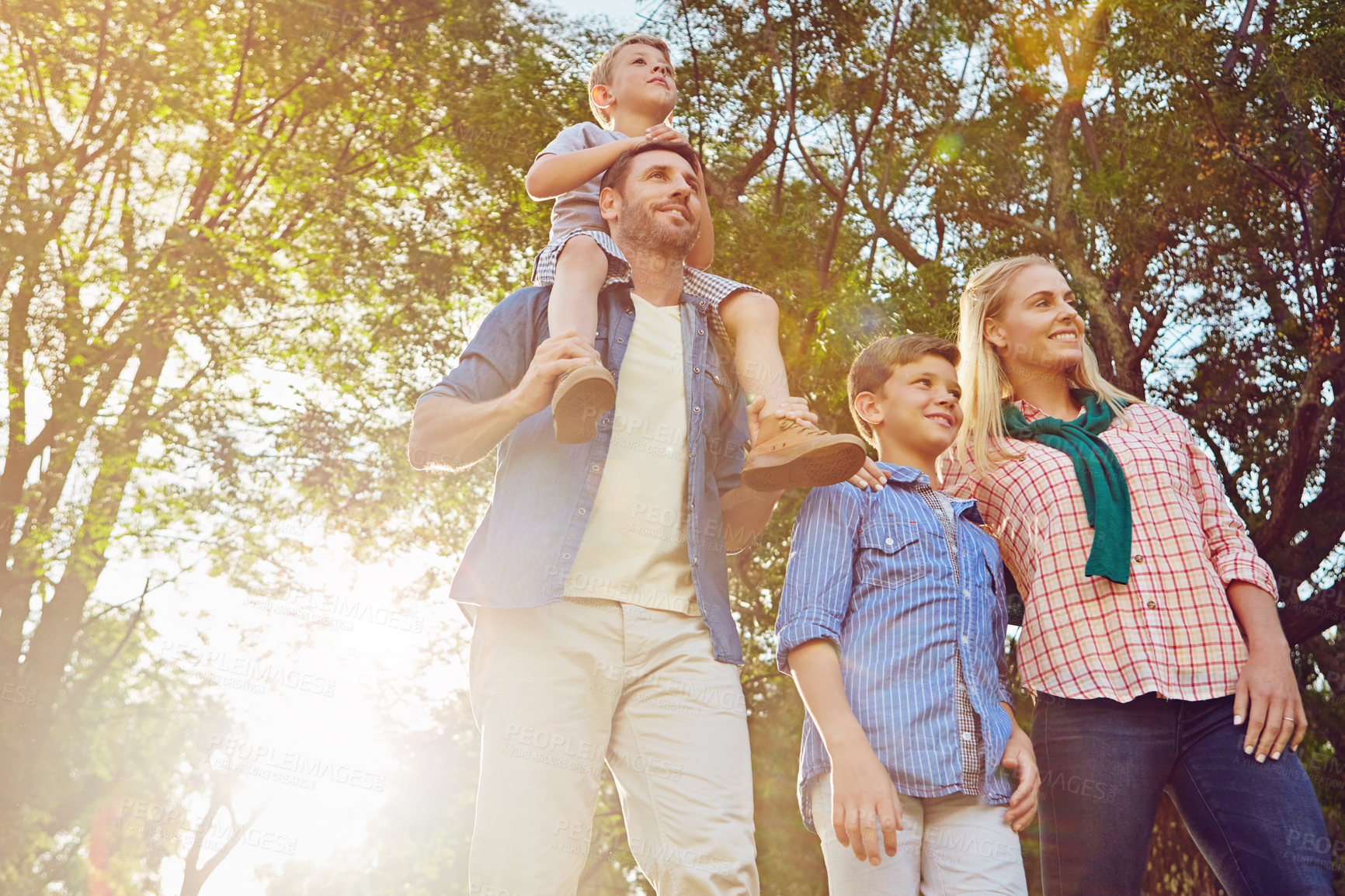 Buy stock photo Cropped shot of a family of four walking in the woods