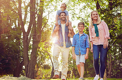 Buy stock photo Full length shot of a family of four walking in the woods