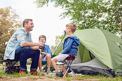 Buy stock photo Shot of a father and his two sons out camping in the woods