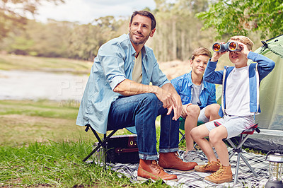 Buy stock photo Shot of a father and his two sons out camping in the woods