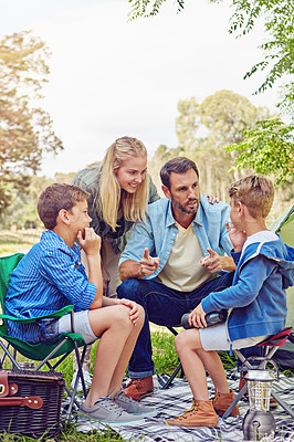 Buy stock photo Shot of a family of four camping in the woods