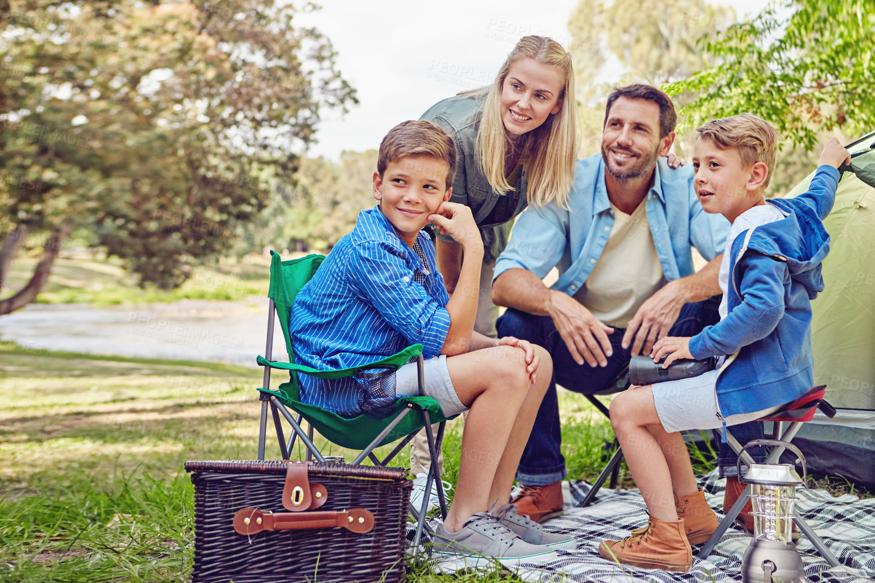 Buy stock photo Shot of a family of four camping in the woods