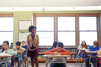 Buy stock photo Shot of a teacher in a classroom with her students
