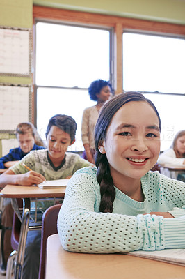 Buy stock photo Portrait, girl and classroom for school, education and learning for exams, test and smile. Teacher, female learner and students focus, thinking and knowledge for development, children and studying