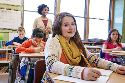 Buy stock photo Portrait, girl in classroom and writing with smile, learning and education for knowledge, focus and book. Teacher, female student and school for studying, development and thinking for test and exam 