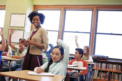 Buy stock photo Shot of a group of children raising their hands to answer their teacher's question