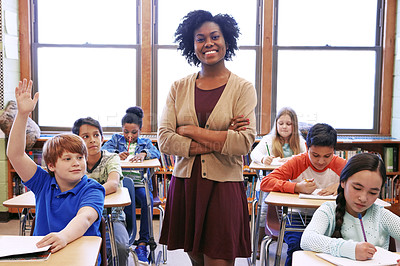 Buy stock photo Learning portrait, black woman and student with question in classroom or school. Education, arms crossed and scholarship boy raising hand to answer questions, studying or help with happy teacher.
