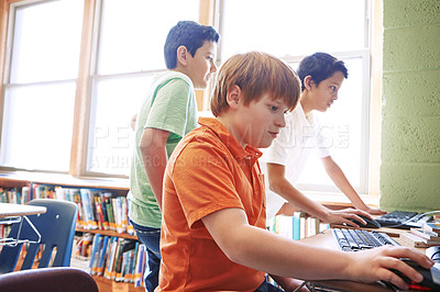 Buy stock photo Shot of elementary children working on computers at school