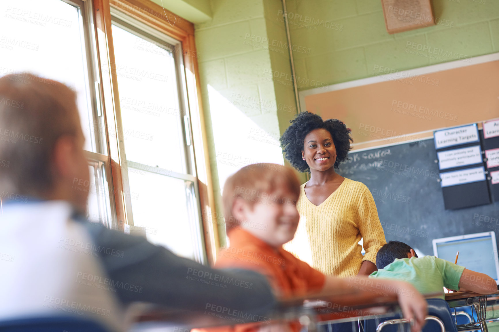 Buy stock photo Shot of a young teacher educating a group of elementary children