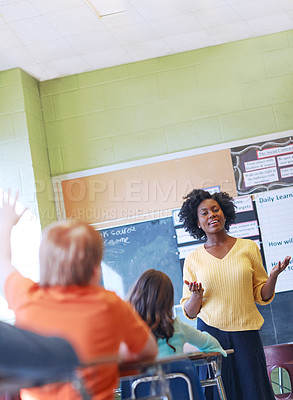 Buy stock photo Shot of a young teacher educating a group of elementary children