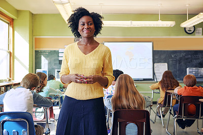 Buy stock photo Portrait, teacher and black woman with students learning in classroom. Education, scholarship and happy, proud and young female educator with children ready for studying or knowledge in middle school
