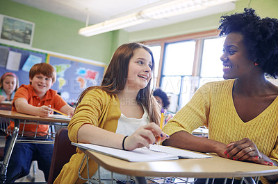 Buy stock photo Learning, education and teacher help student with assignment in elementary school. Classroom support, scholarship and happy black woman or educator aid, explaining and helping girl learner in class.