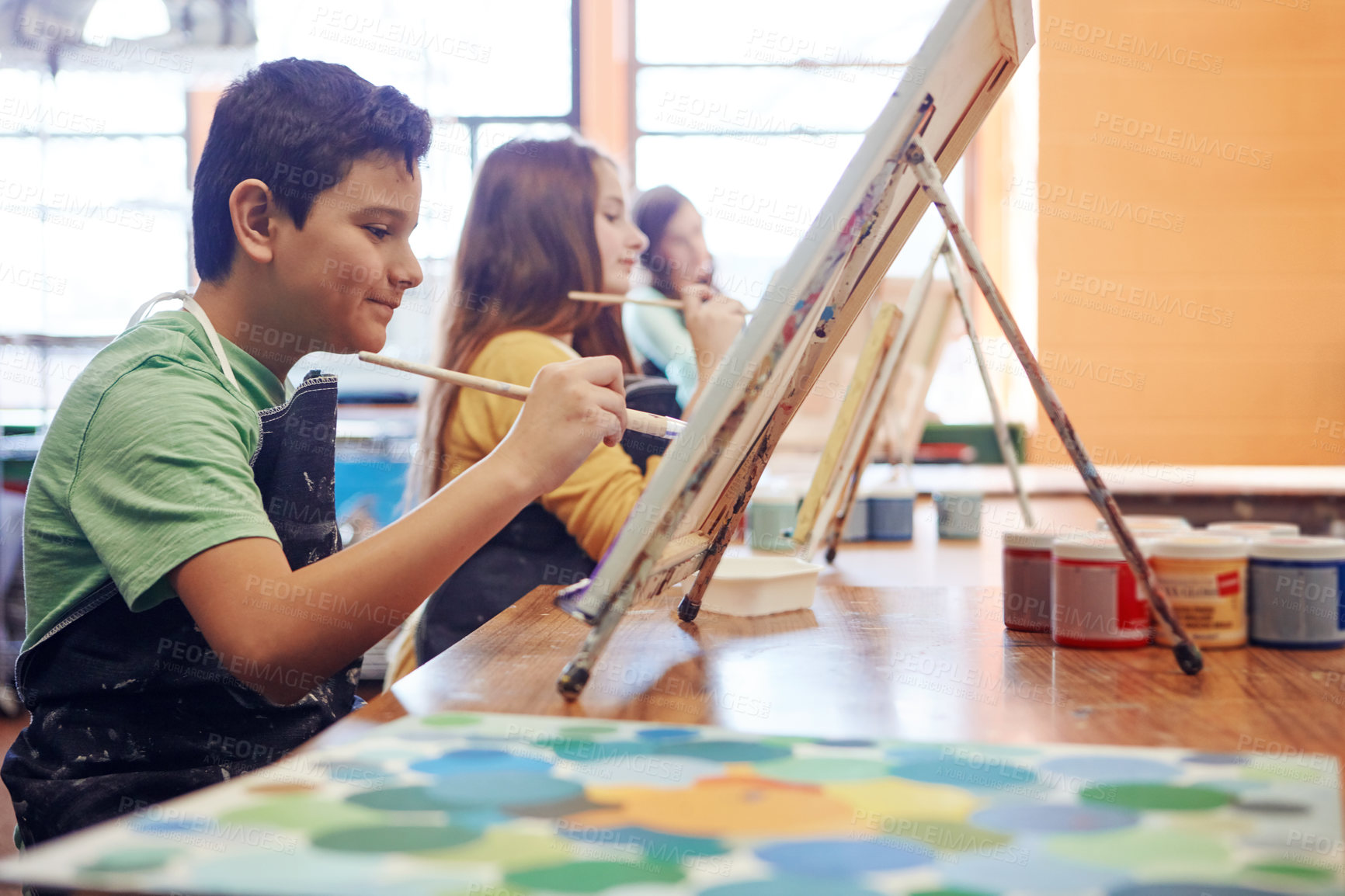 Buy stock photo Shot of a young schoolboy in an art class