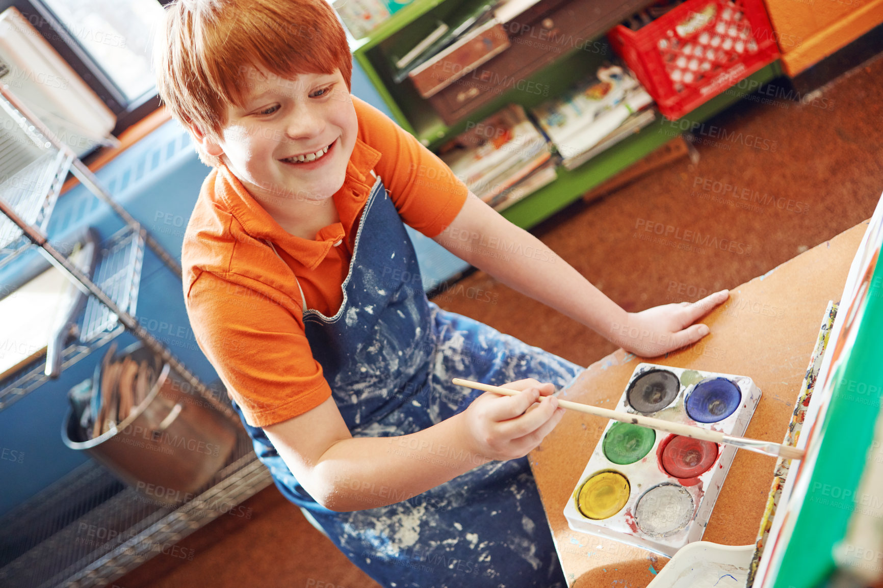 Buy stock photo Shot of a young schoolboy in an art class