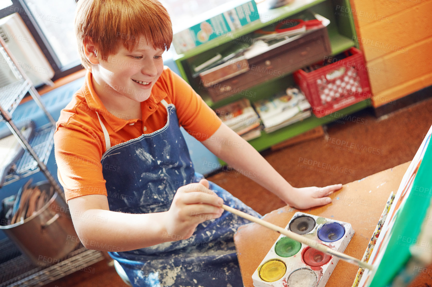 Buy stock photo Shot of a young schoolboy in an art class