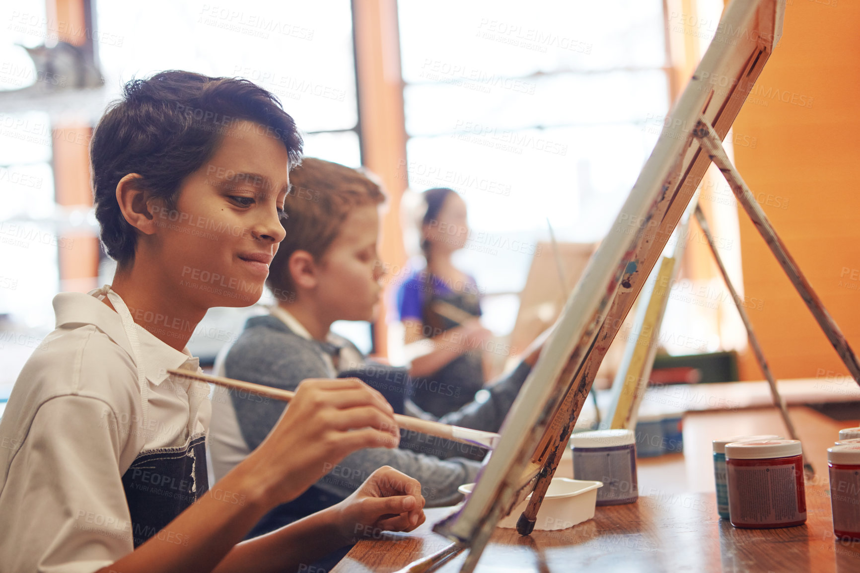 Buy stock photo Shot of a young schoolboy in an art class