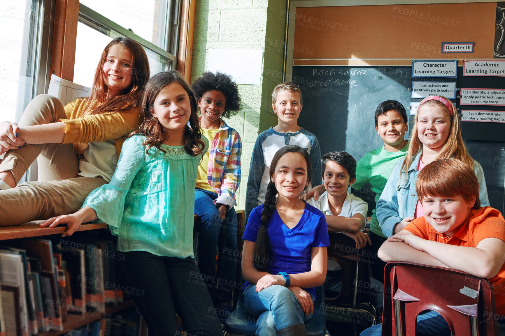 Buy stock photo Shot of a group of elementary school children sitting in a classroom