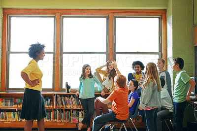 Buy stock photo Shot of a young boy raising his hand to answer his teacher's question