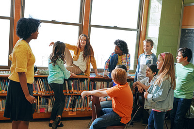 Buy stock photo Education library, teacher and children students in classroom of elementary school. Development, learning scholarship and group of kids talking, discussion and studying for knowledge with black woman