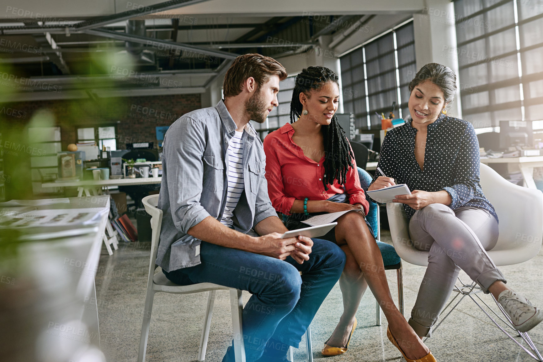 Buy stock photo Shot of a group of colleagues having a brainstorming session in a modern office