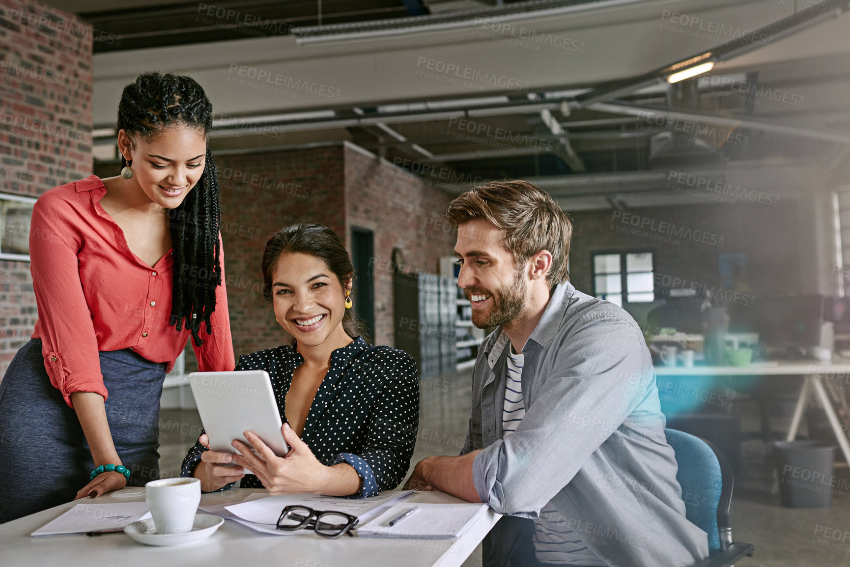 Buy stock photo Shot of a group of colleagues having a brainstorming session in a modern office