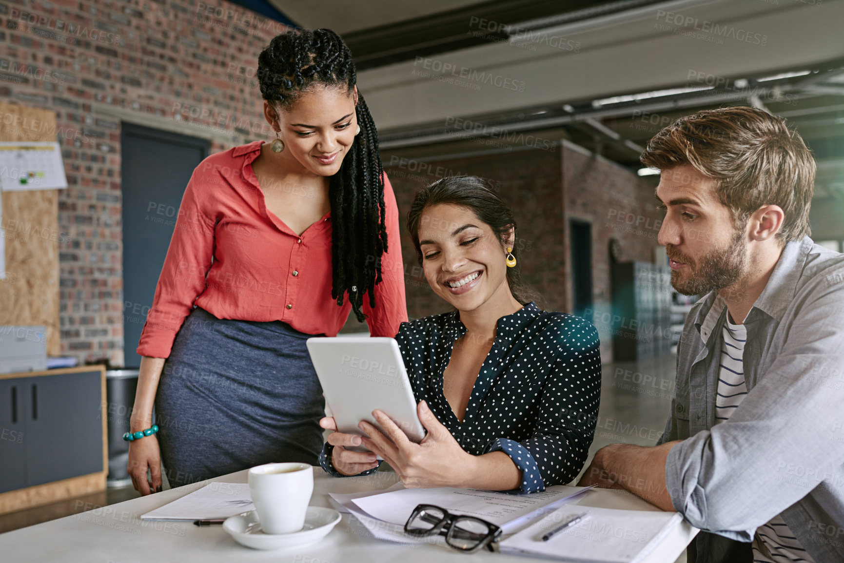 Buy stock photo Shot of a group of colleagues having a brainstorming session in a modern office