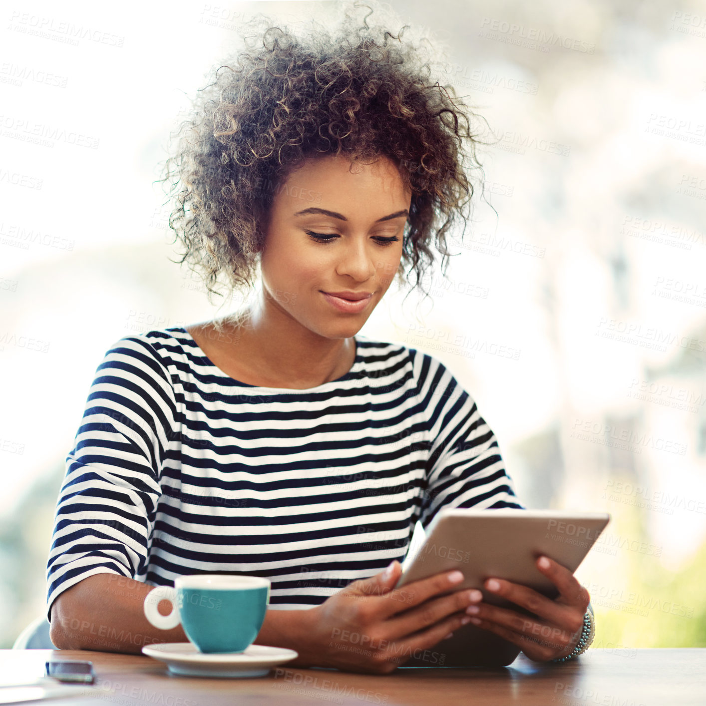 Buy stock photo Shot of a young woman working at home with a digital tablet