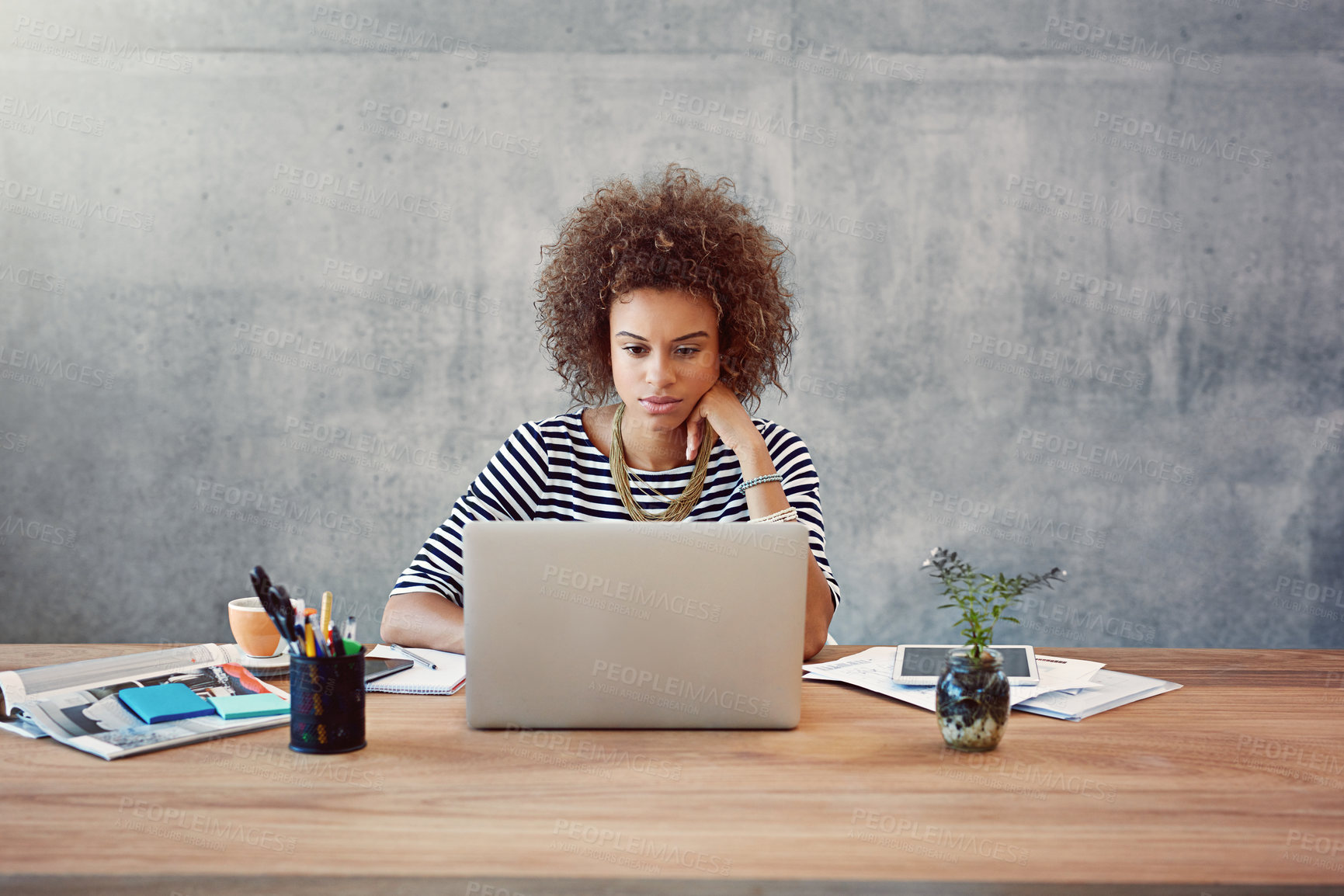 Buy stock photo Shot of a young woman working on a laptop at home