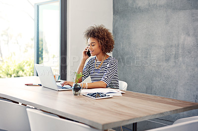 Buy stock photo Shot of a young woman talking on the phone while working at her desk at home