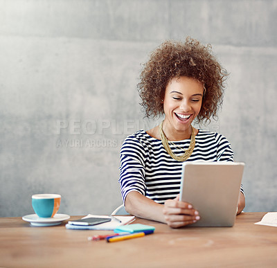 Buy stock photo Shot of a young woman working from home with a digital tablet