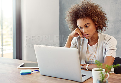 Buy stock photo Shot of a stressed looking  young woman working on a laptop at home