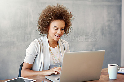 Buy stock photo Shot of a young woman working on a laptop at home