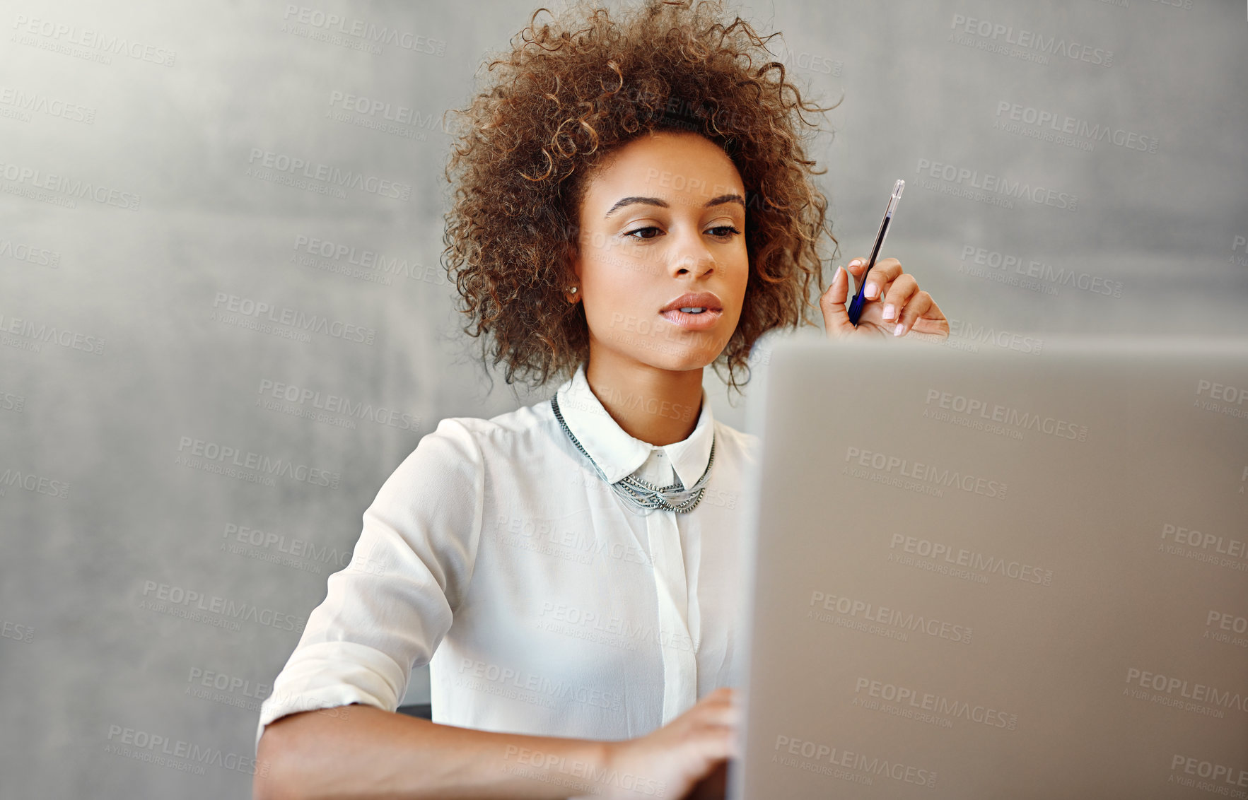 Buy stock photo Woman, laptop and working for creative business, agency by gray wall or online appointment reading email. Website, searching and internet in workplace, digital schedule and secretary in office