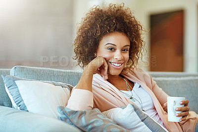 Buy stock photo Portrait of a young woman relaxing with a warm beverage at home