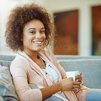 Buy stock photo Portrait of a young woman relaxing with a warm beverage at home