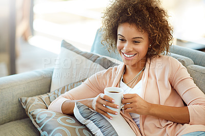 Buy stock photo Shot of a young woman relaxing with a warm beverage at home