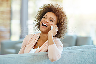 Buy stock photo Shot of a young woman talking on her phone on a relaxing day at home