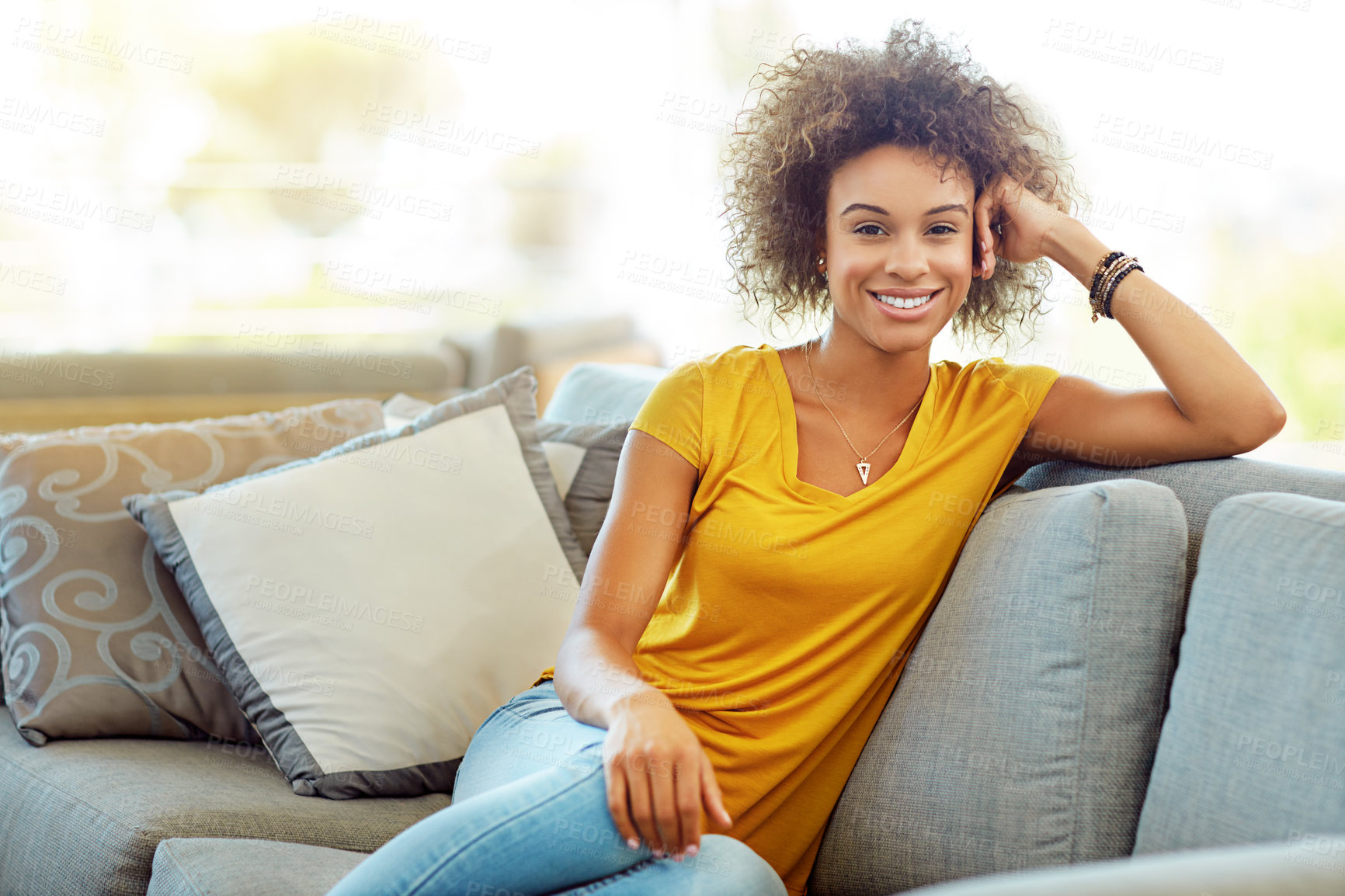 Buy stock photo Portrait of a young woman relaxing on the sofa at home