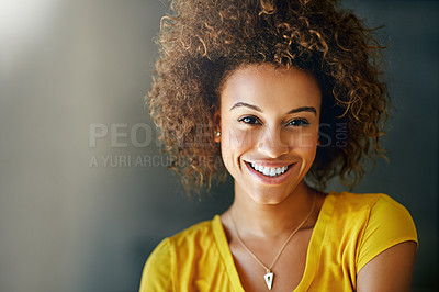 Buy stock photo Studio portrait of a happy young woman posing against a dark background
