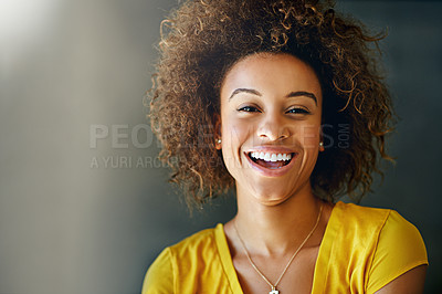 Buy stock photo Studio portrait of a happy young woman posing against a dark background