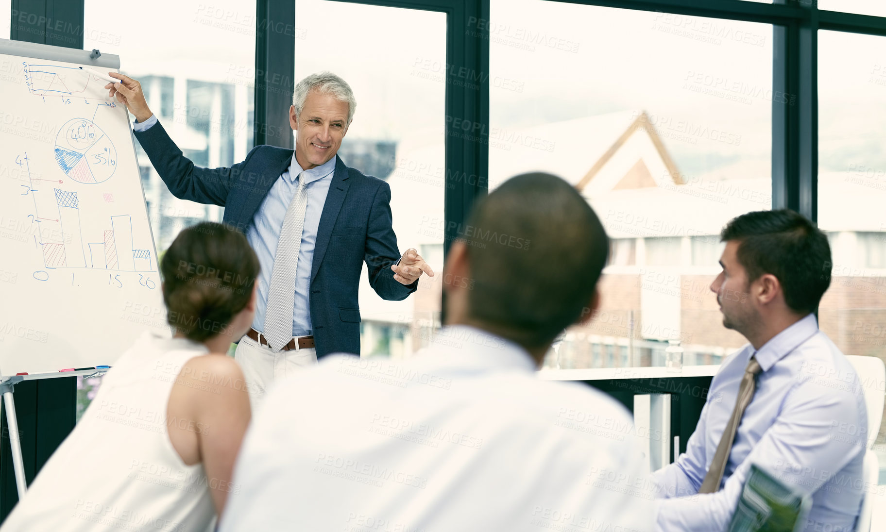 Buy stock photo Shot of a group of businesspeople in a presentation