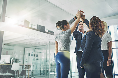 Buy stock photo Successful group of business people giving a high five in support team building achievement. Work colleagues celebrating good teamwork project together in modern conference office
