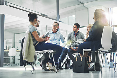 Buy stock photo Shot of a group of coworkers talking together while sitting in a circle in an office