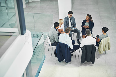 Buy stock photo Diverse group of businesspeople, employees and colleagues in seminar planning, sitting and talking around in a circle. Coworkers having a meeting about a project at the office in corporate firm. 
