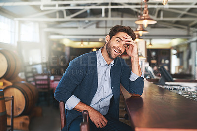 Buy stock photo Cropped portrait of a handsome young man sitting in a bar