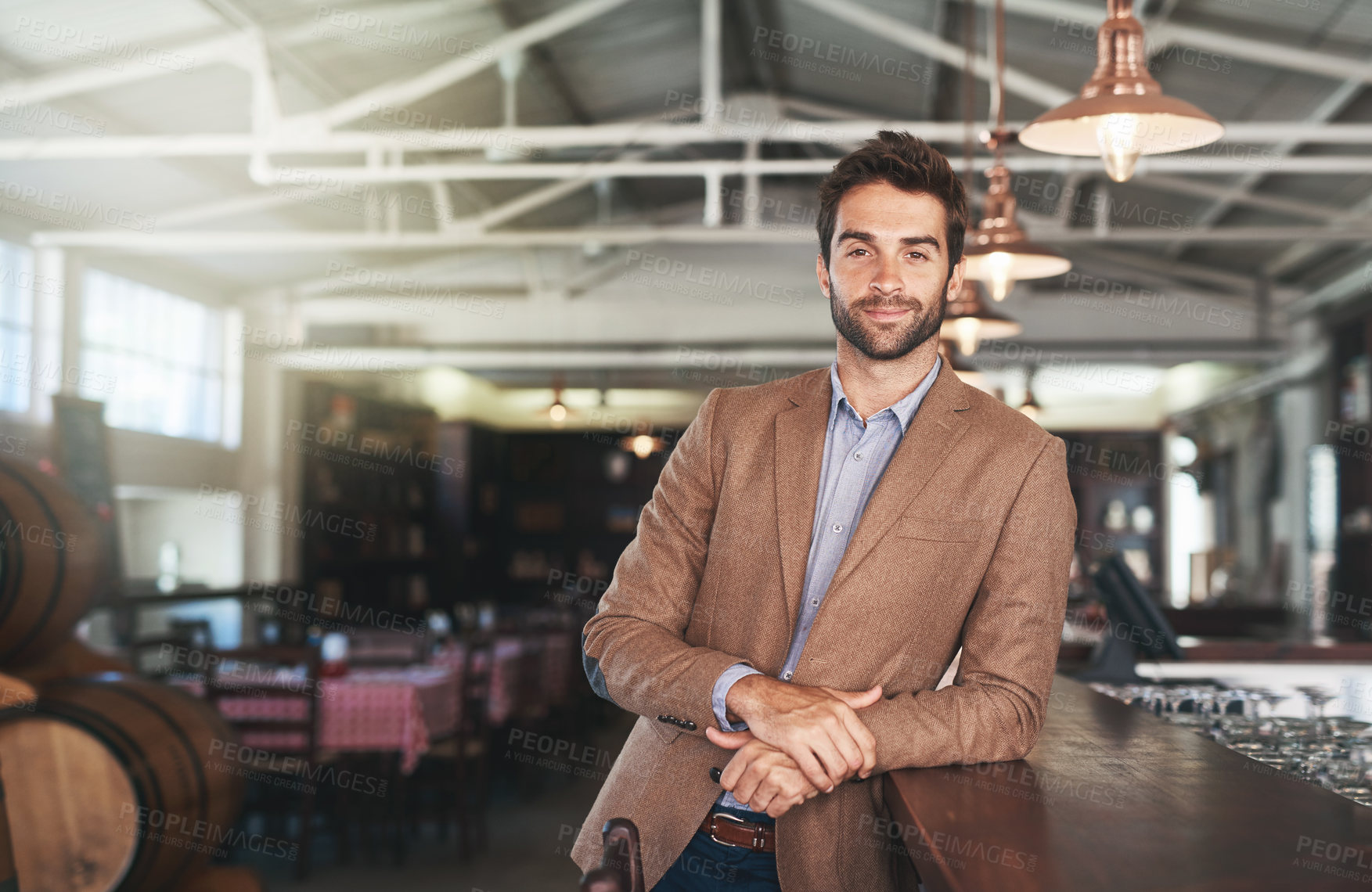 Buy stock photo Cropped portrait of a handsome young man standing in a bar