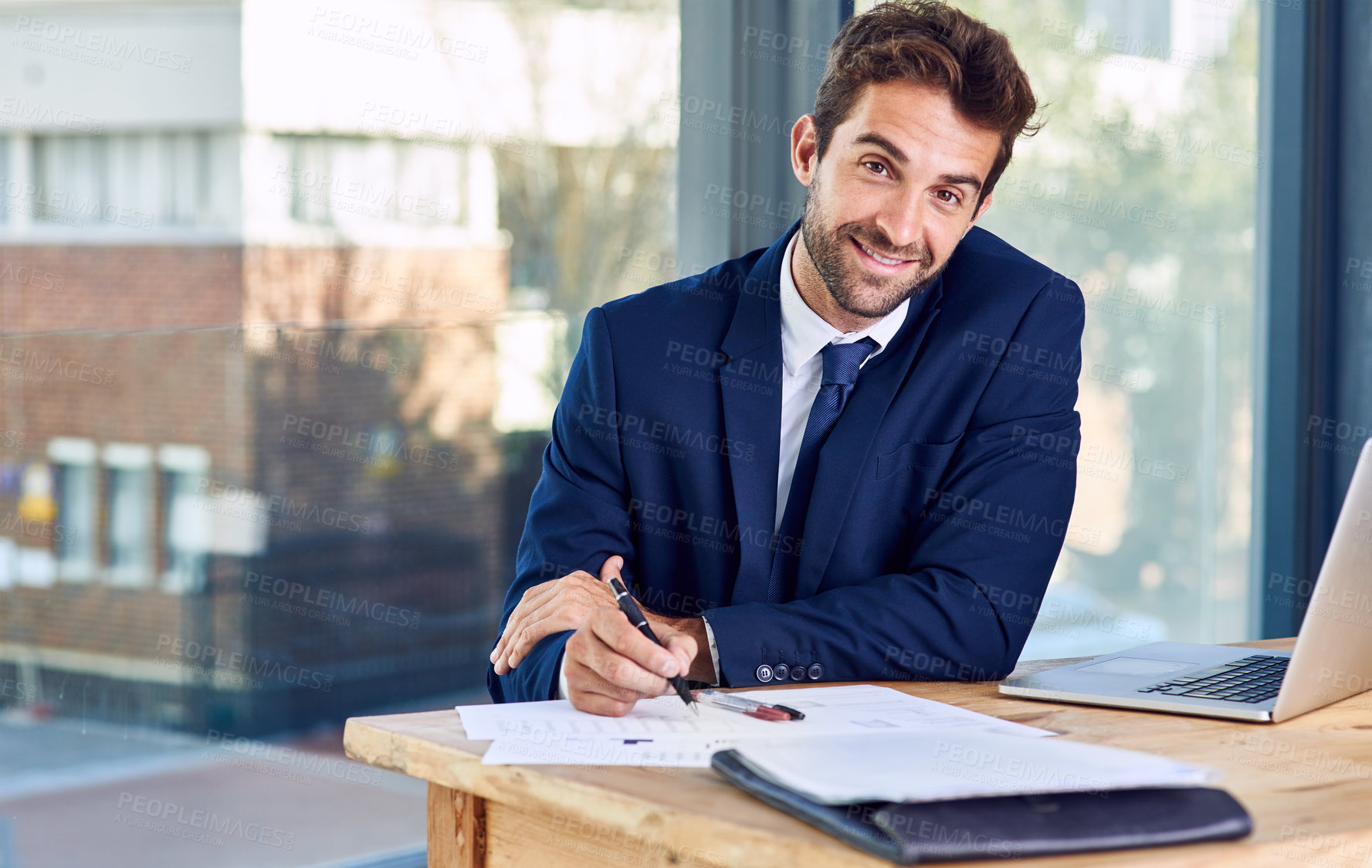 Buy stock photo Portrait, laptop and businessman with paperwork for signing, reading and document in office. Contract, project agreement and consultant with new opportunity, deal or computer to connect in workplace