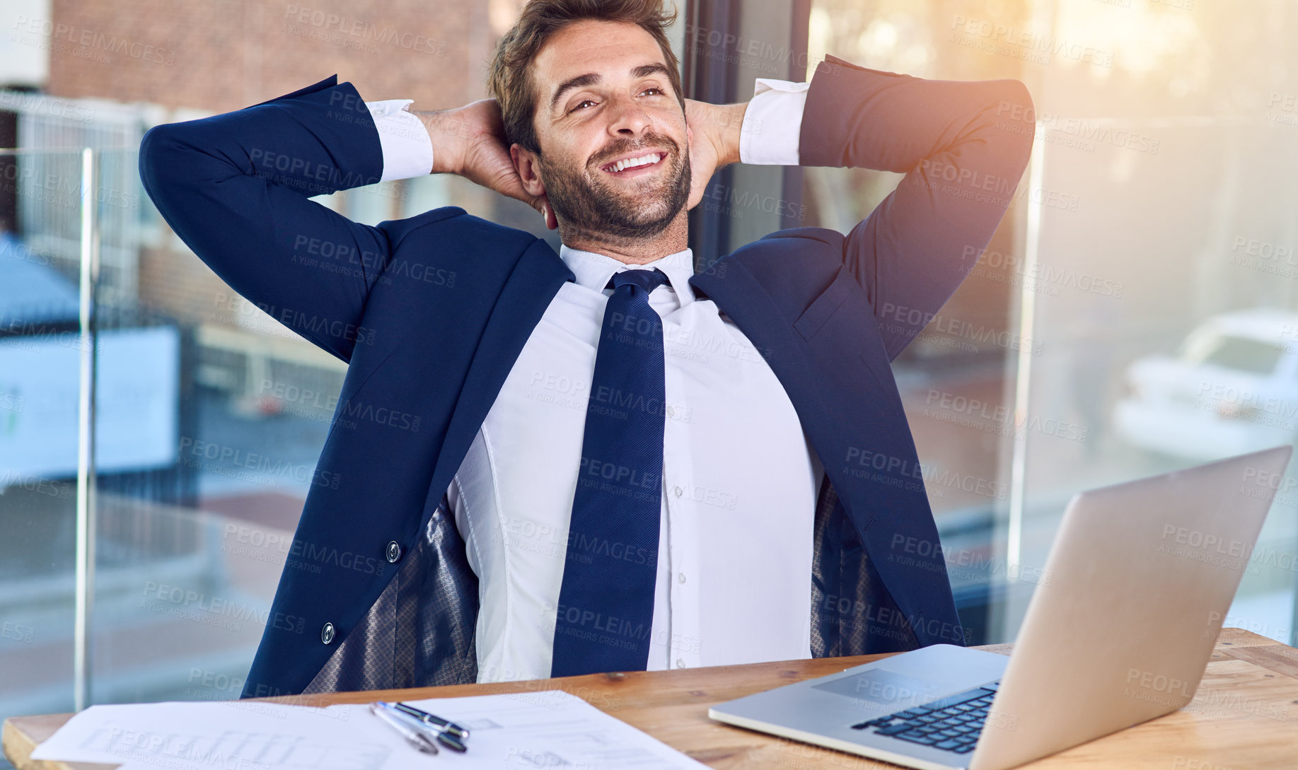 Buy stock photo Shot of a businessman looking relaxed in his office